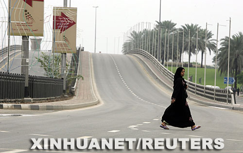 1月14日，一名阿拉伯联合酋长国妇女行走在迪拜空空荡荡的街头。