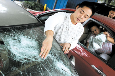 11名持刀黑衣男子当着车主面砸烂两轿车(图)